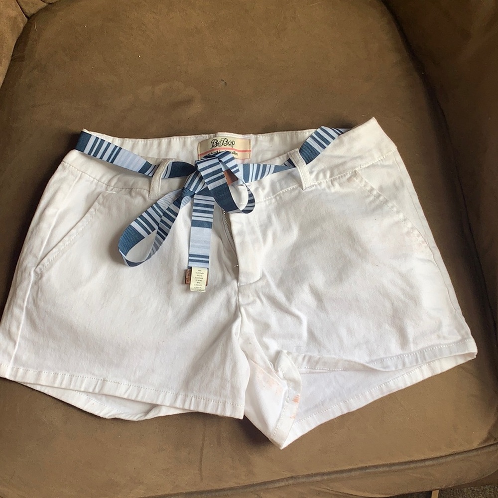 White shorts with a blue and white belt